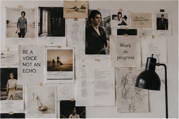 Creative reference wall filled with photographs, notes and project fragments